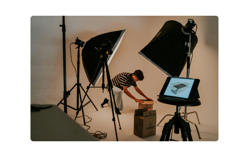 Studio setup for eCommerce video ads with lighting, camera, and product packaging for a professional shoot.